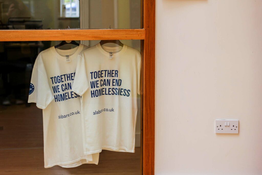 Alabare Together we can end homelessness T shirts hanging up