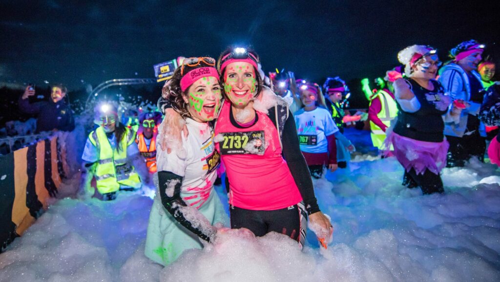 Two women fundraisers at an alabare Glow in the Park at Longleat
