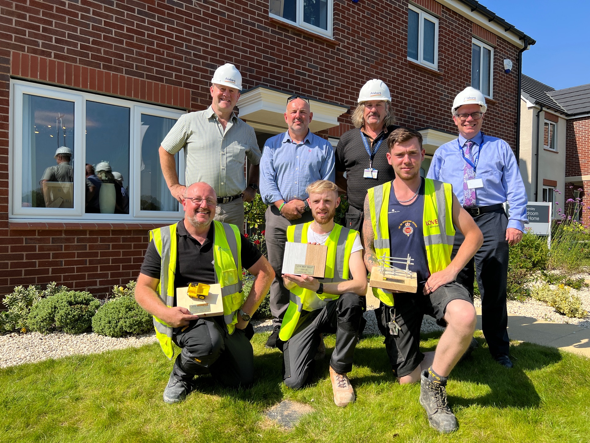Veterans in front of a self build house