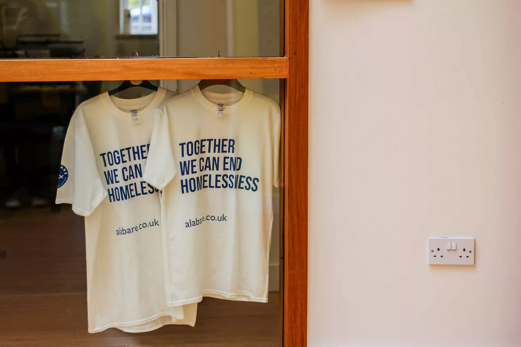 Alabare t shirts hanging up that say Together We Can End Homelessness